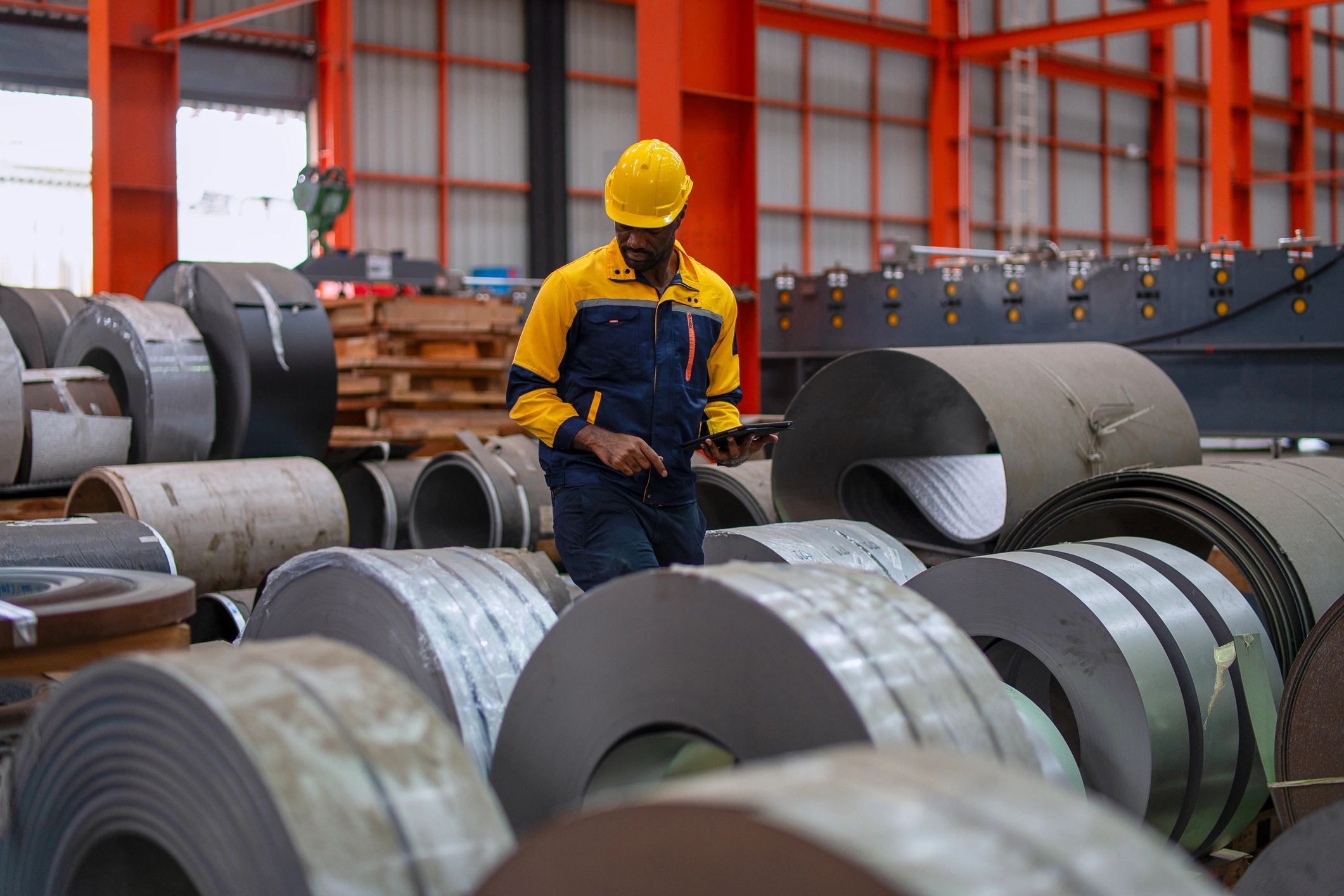 Industrial worker maintaining equipment in a manufacturing facility